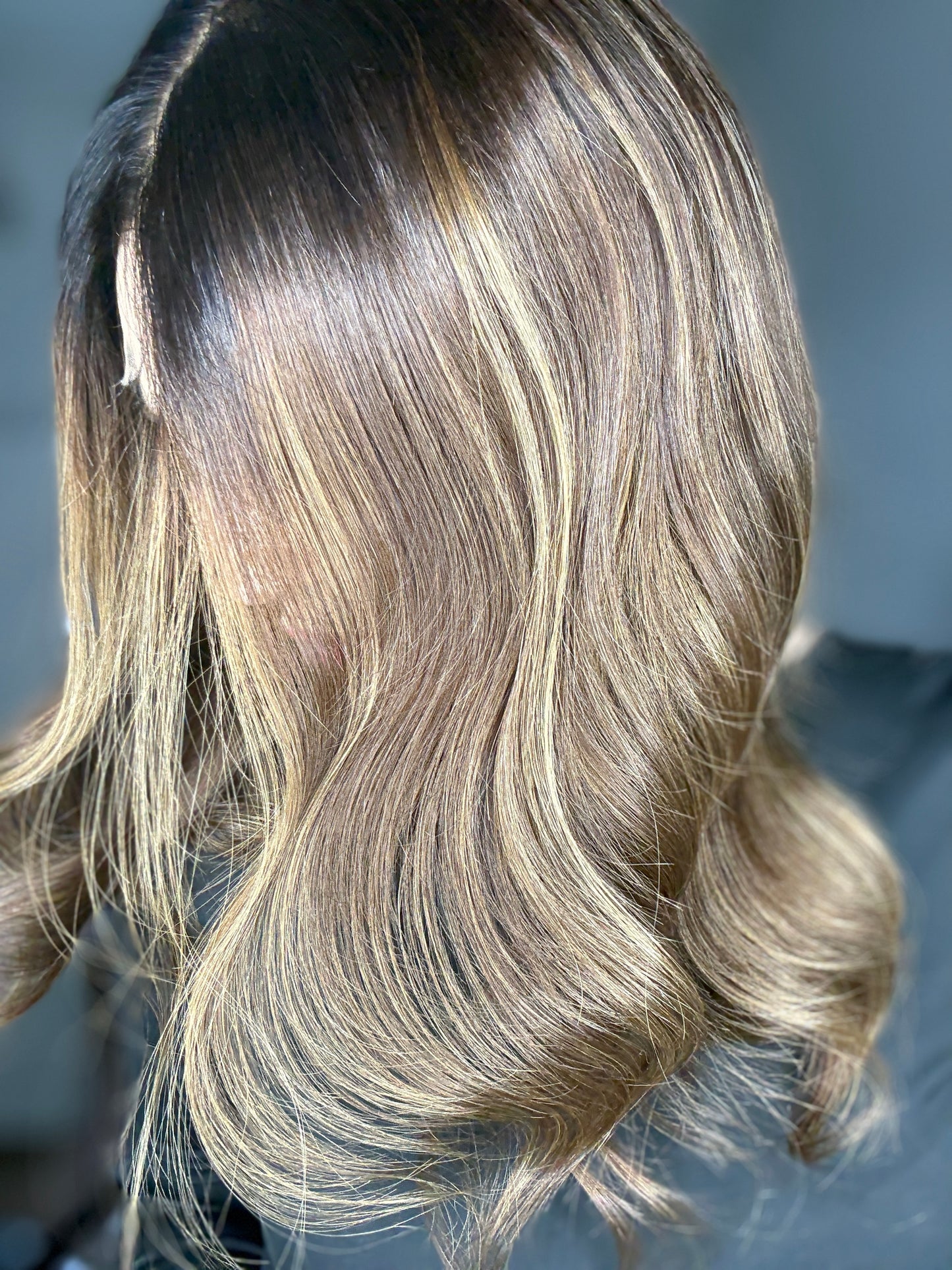 Brown wig with warm highlights and dark roots